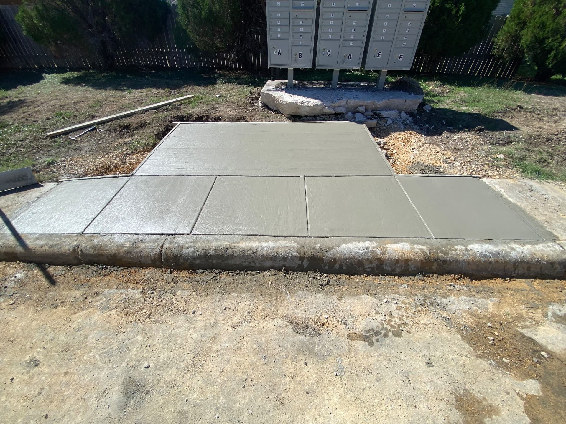New concrete mailbox pad and level landing poured at a neighborhood cluster box
