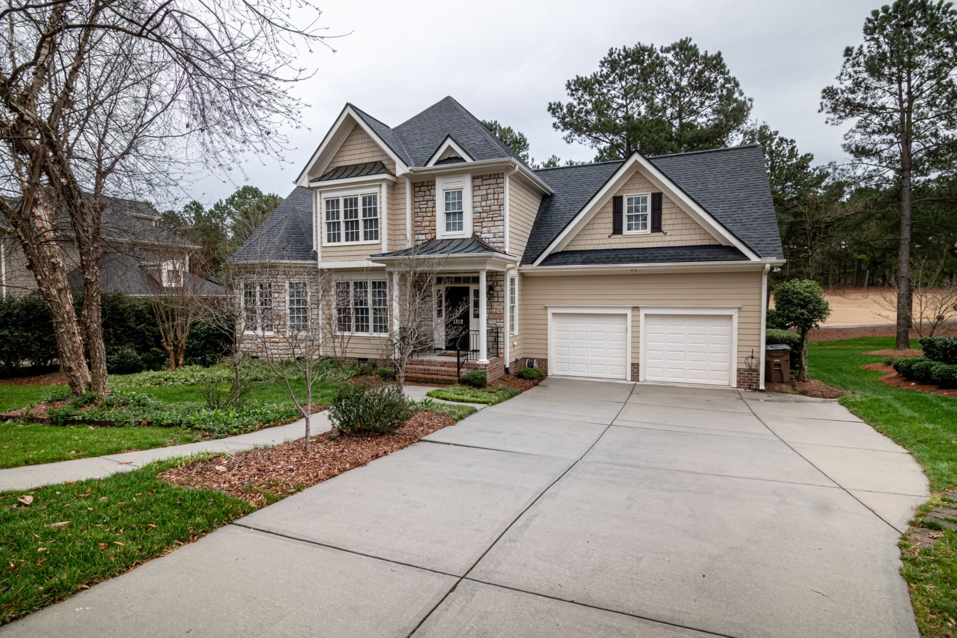 New concrete driveway leading to a two-car garage on a San Antonio area home