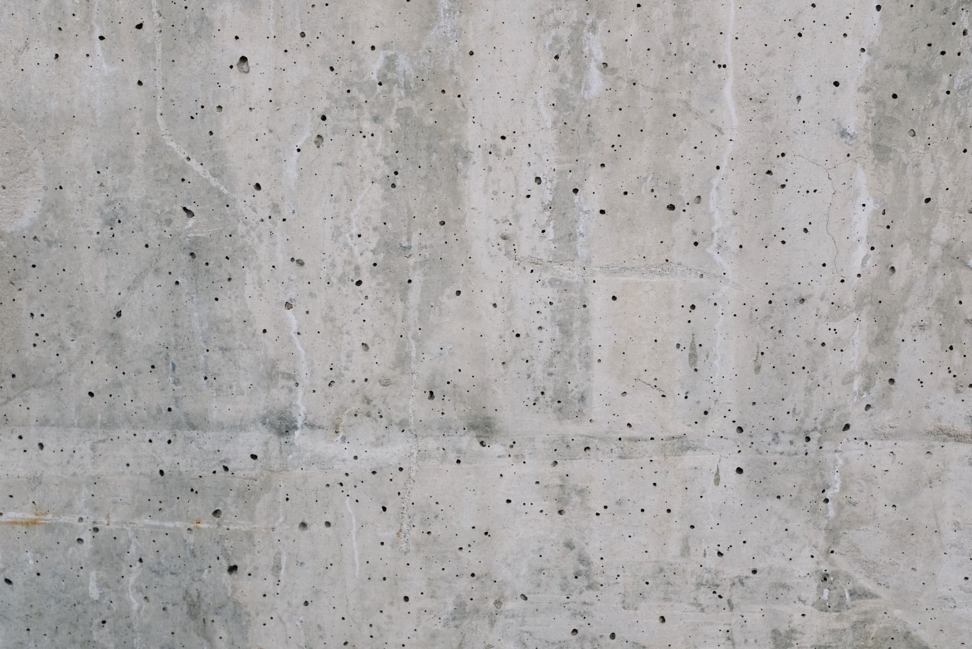 Board-formed concrete retaining wall face with visible form lines and texture